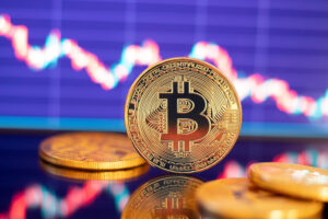 Moeda de Bitcoin com gráfico em segundo plano