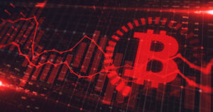 Símbolo do Bitcoin em mercado de baixa exposto por gráfico de preço